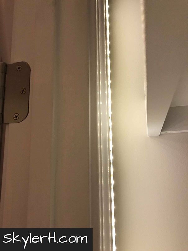 An LED light strip adhered to the inside of the door frame in my linen closet. Mounted here, it's hidden from an outside viewer but illuminates the closet shelves nicely.